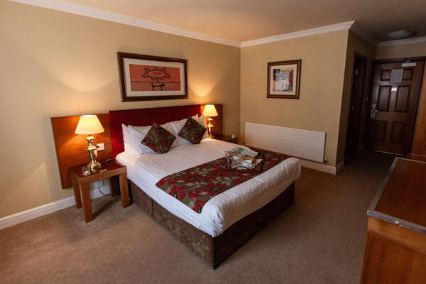 Cosy hotel room with a king-size bed, warm lighting, and elegant decor at Hamlet Court Hotel.