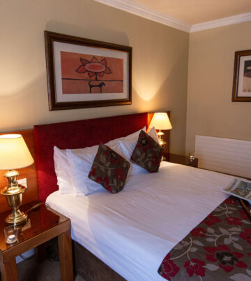Cosy hotel room with warm lighting and floral decor at Hamlet Court Hotel.