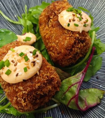 Delicious croquettes atop fresh greens with a creamy, spicy sauce at Hamlet Court Hotel.