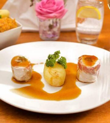 Elegant dining setup at Hamlet Court Hotel with gourmet meal and wine.