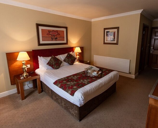 Cosy hotel room with double bed and warm lighting, Hamlet Court Hotel.