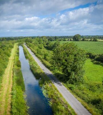 Scenic countryside view near Hamlet Court Hotel with lush greenery and serene waterway.
