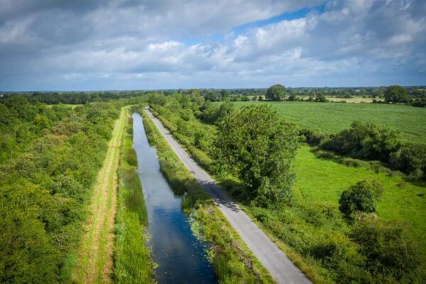 Scenic countryside view near Hamlet Court Hotel with lush greenery and serene waterway.