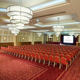 Elegant conference room with red seating at Hamlet Court Hotel