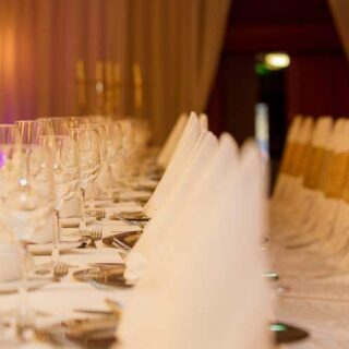 Elegant dining setup at Hamlet Court Hotel with white linens and glassware.