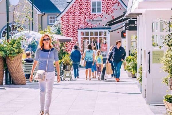 Charming courtyard at Hamlet Court Hotel, surrounded by vibrant flowers and quaint shops.