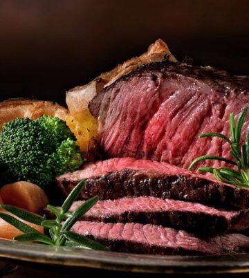 Juicy roast beef with vegetables, creating a warm, inviting dining experience.