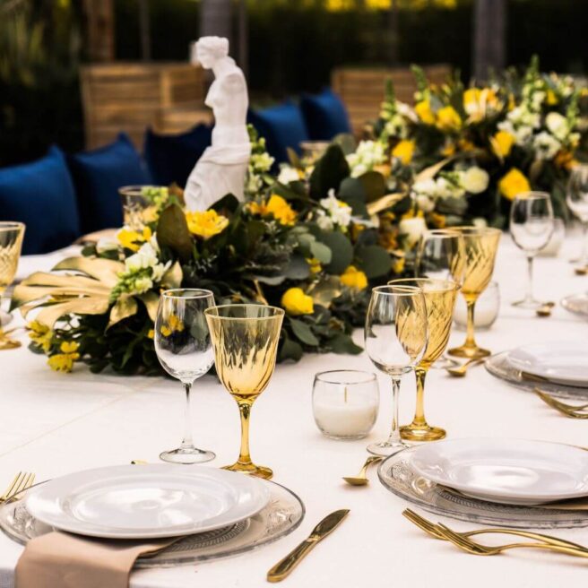 Elegant outdoor dining setup at Hamlet Court Hotel, adorned with yellow floral centrepieces.
