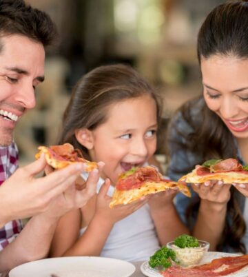 Family enjoying pizza at Hamlet Court Hotel restaurant.