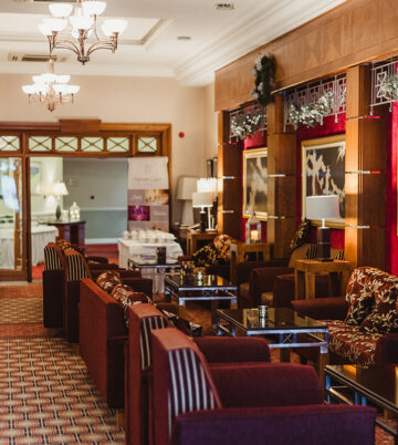 Elegant hotel lobby with festive decor and cosy seating area
