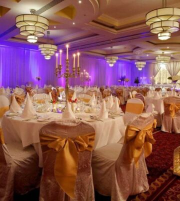 Elegant ballroom with purple lighting and candlelit tables at Hamlet Court Hotel.