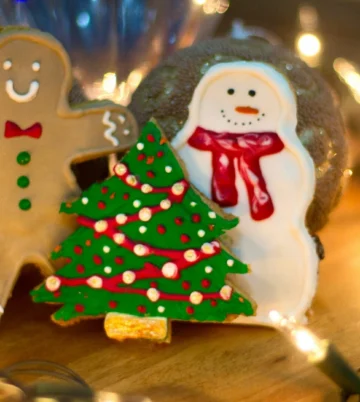 Festive gingerbread man, decorated tree and snowman cookie on warm wooden table with fairy lights, Hamlet Court Hotel